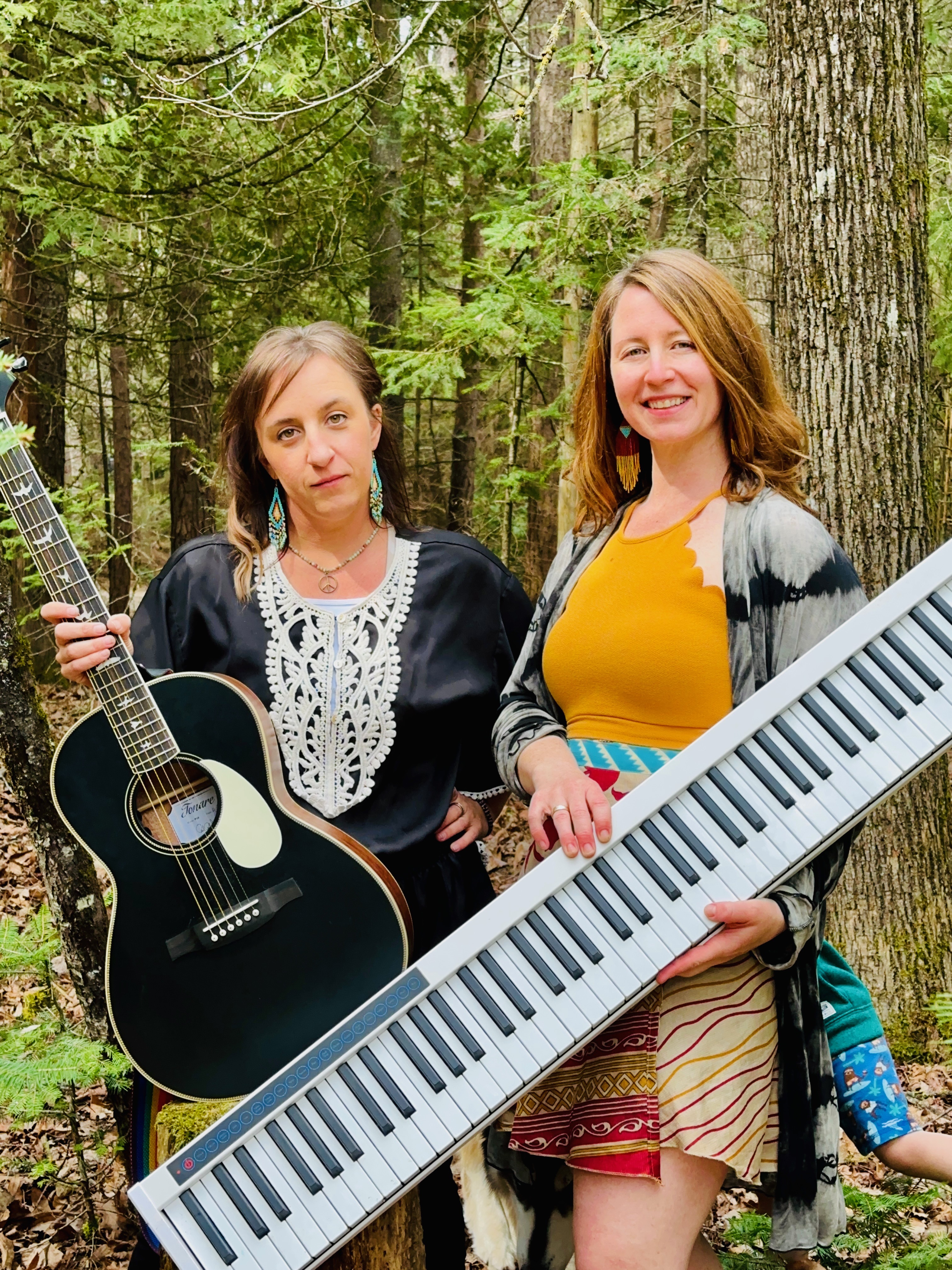 The duo posed with guitar and electric keyboard among the pines.